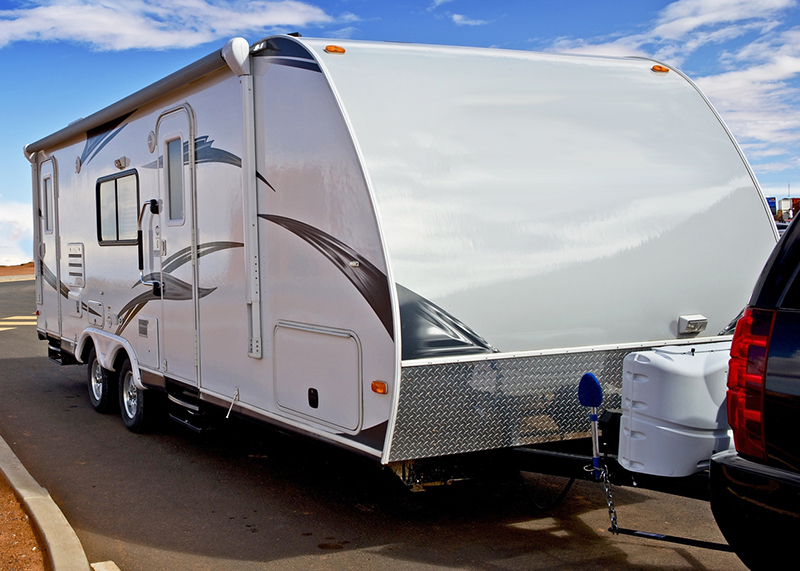 Towable camper vehicle seen while preforming rv inspection services alongside the road