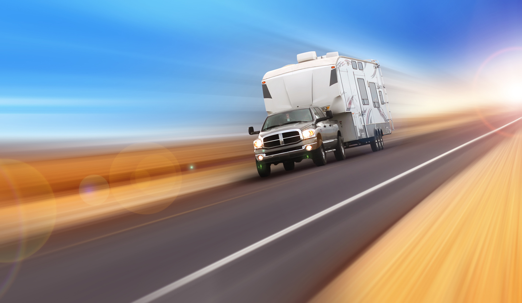 Recreation vehicle trailer being pulled by a truck down the highway after rv inspection services were preformed
